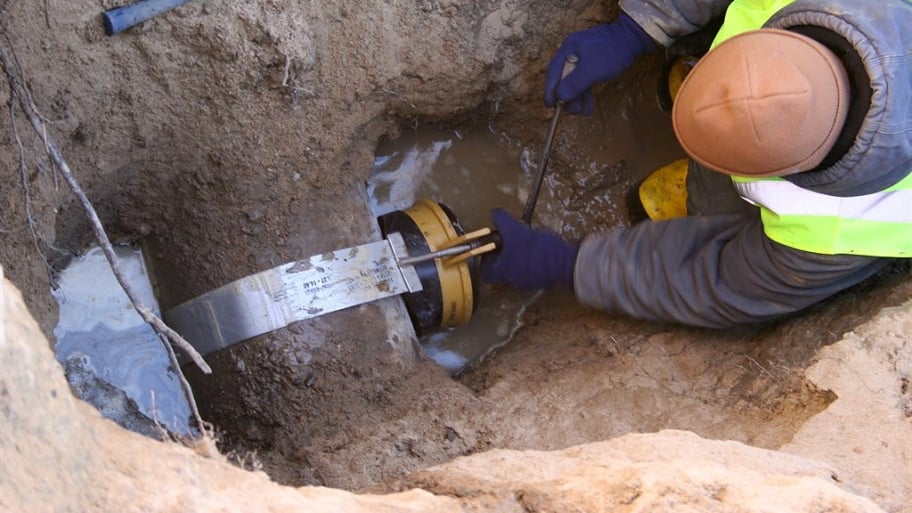 Worker repairing sewer line